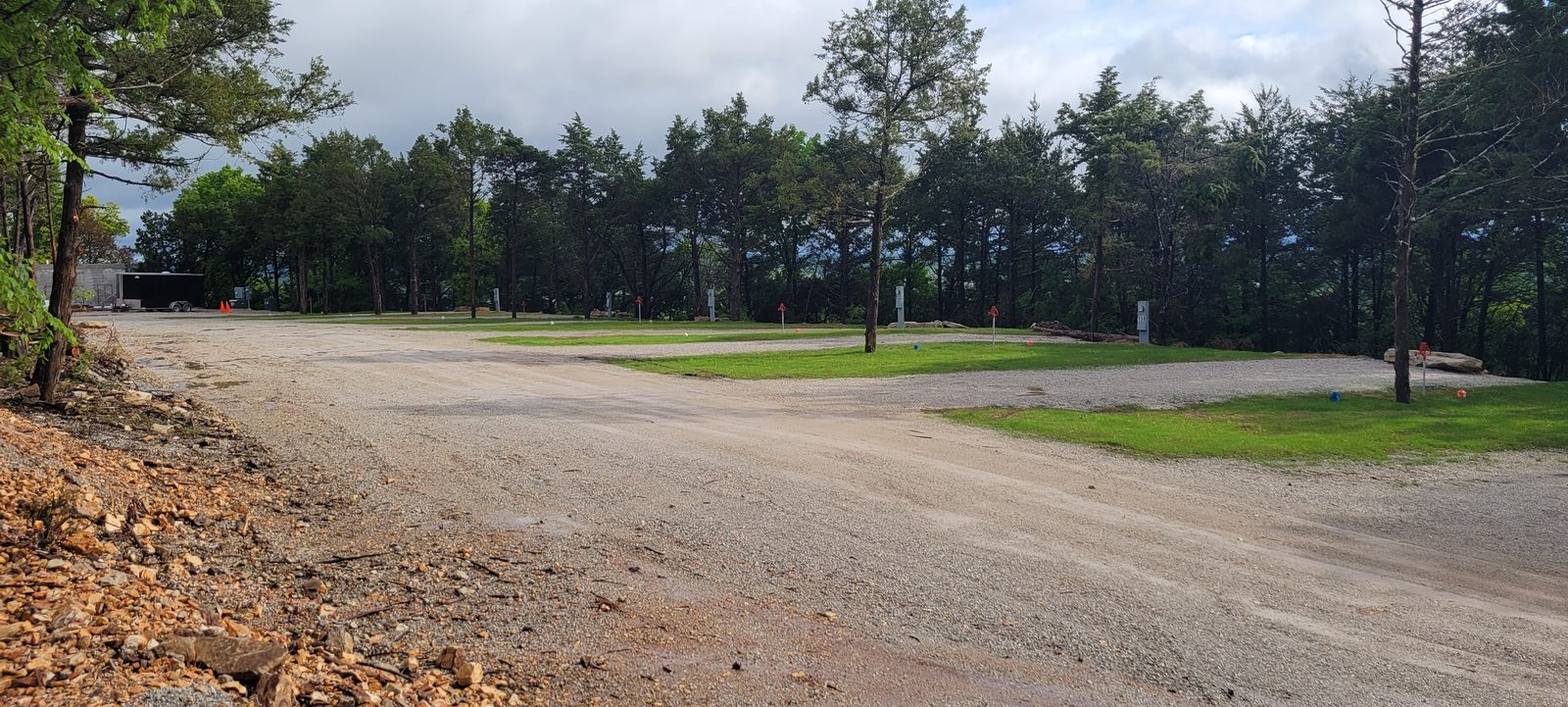 A grassy full-hookup site with a utility pedestal ready for an RV.